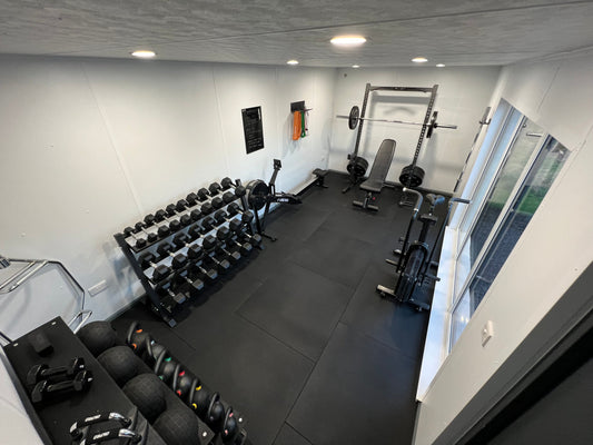 Home gym setup with barbell, Bumper plates, Squat Rack, Hex Dumbbells, Rower and Assault bike - Rock Solid Fitness Ireland